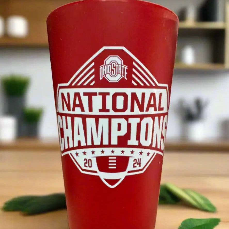 Red cup with 'National Champions' text on a wooden surface
