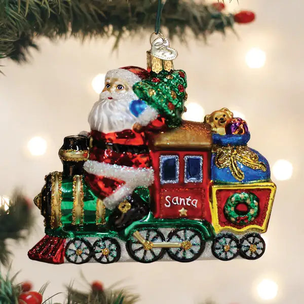 Decorative Christmas ornament of Santa Claus on a train with festive decorations.