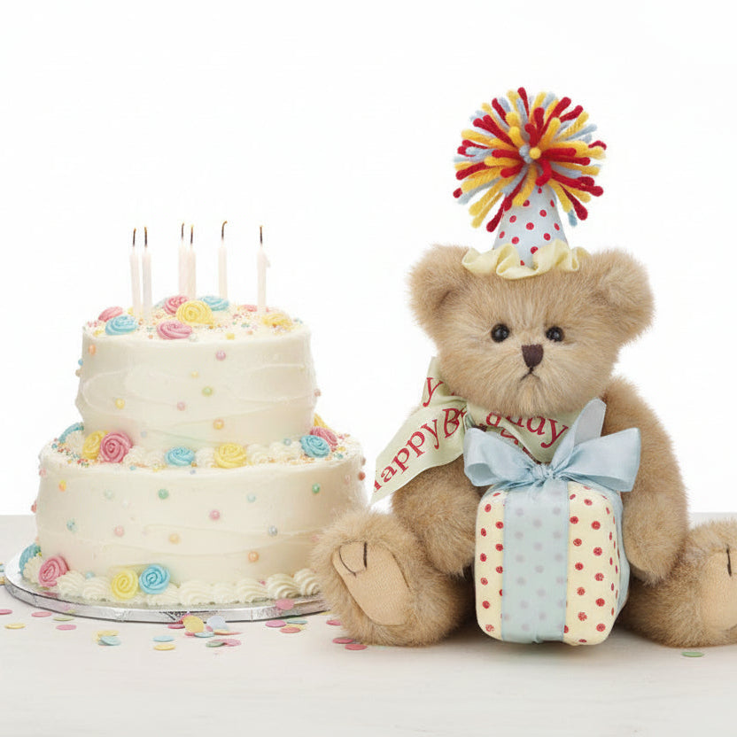 Teddy bear with a birthday cake and candles on a white background