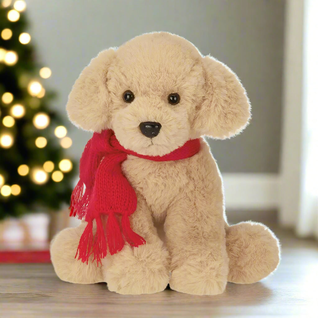Beige stuffed dog with a red scarf on a white background