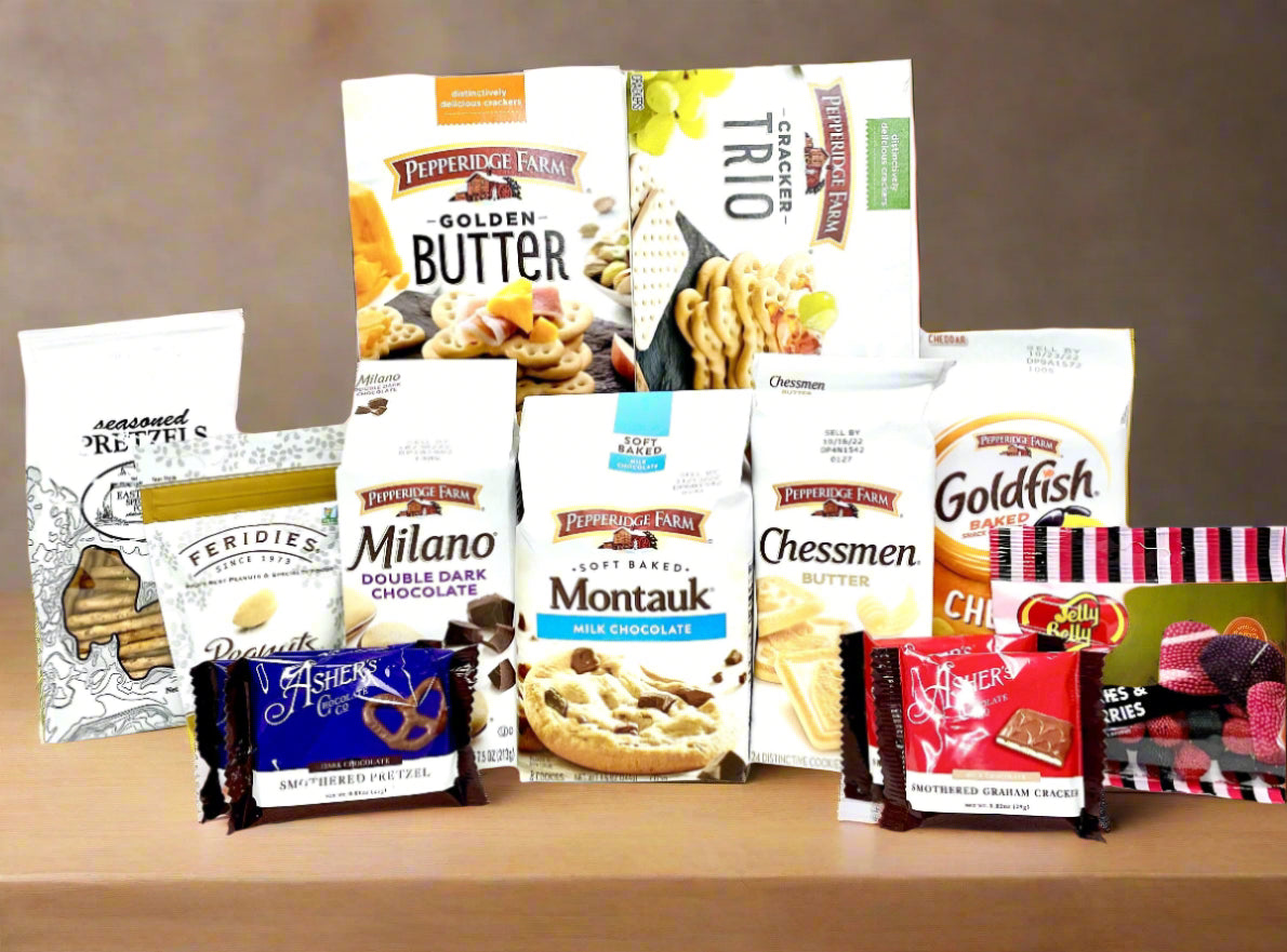 Gift basket with a blue bow containing snacks and treats on a neutral background