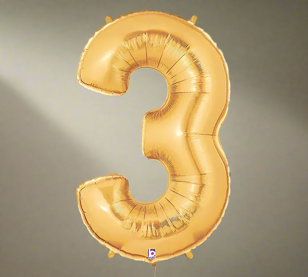 Gold number 3 balloon on a white background