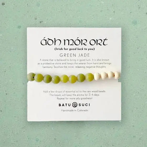 Green jade beaded bracelet on a card with text on a green background