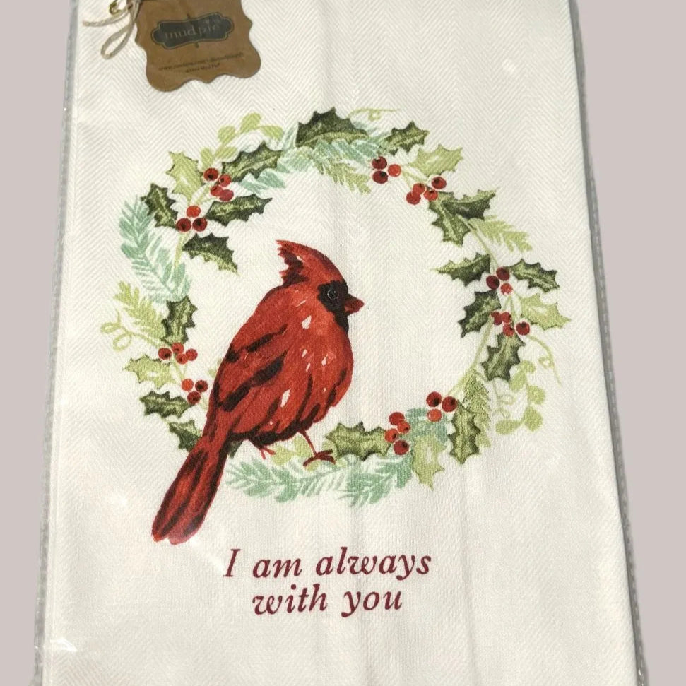 Decorative towel with a red cardinal and holly wreath design, featuring the text 'I am always with you'.