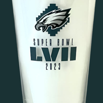 Glass with Philadelphia Eagles logo and Super Bowl LVII 2023 text on a white background