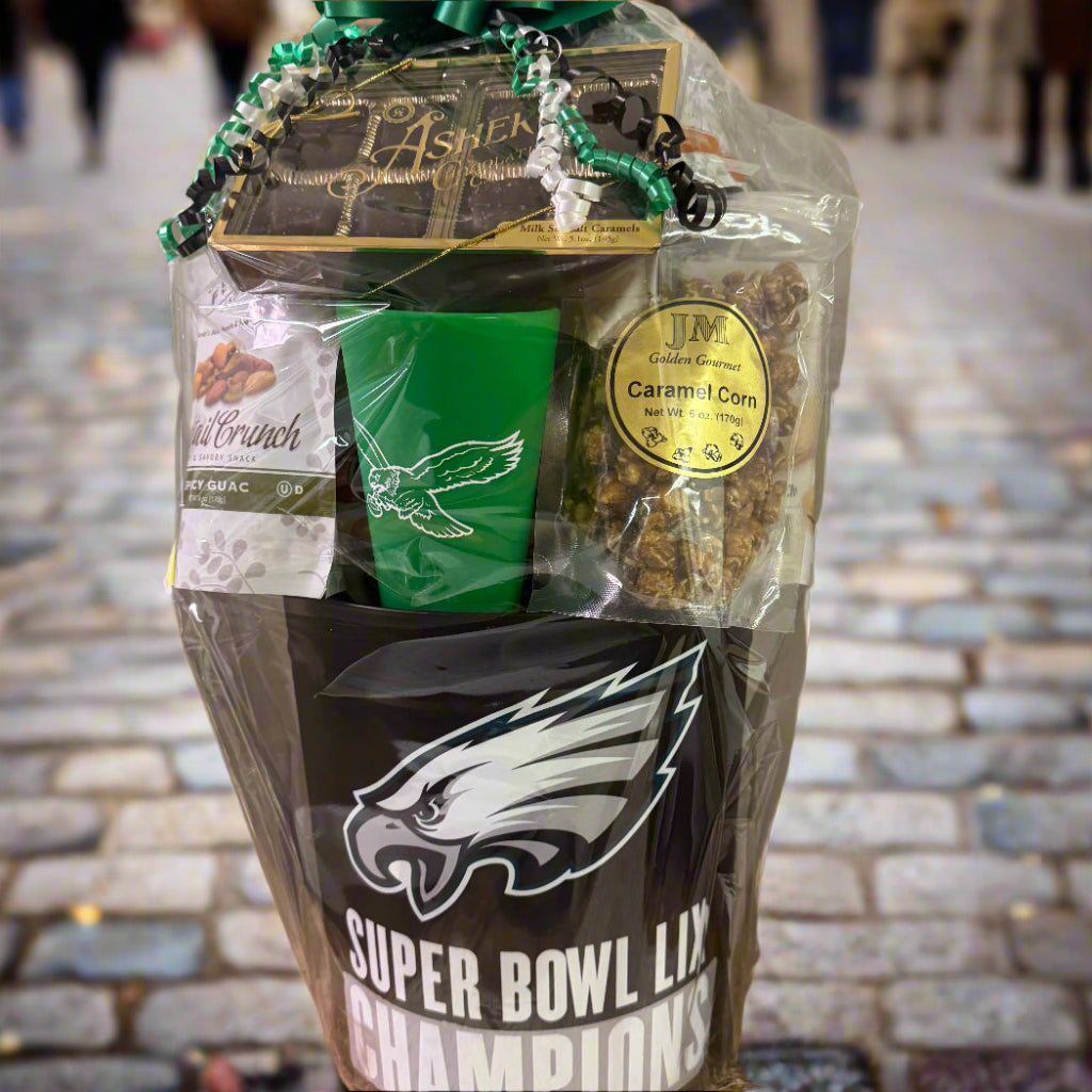 Gift basket with Super Bowl LIX Champions design, green cup, and snacks on a neutral background