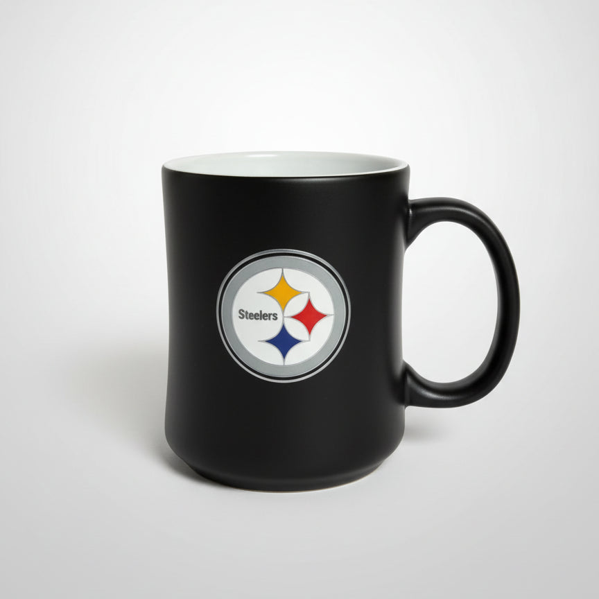 Black mug with a sports team logo on a wooden surface