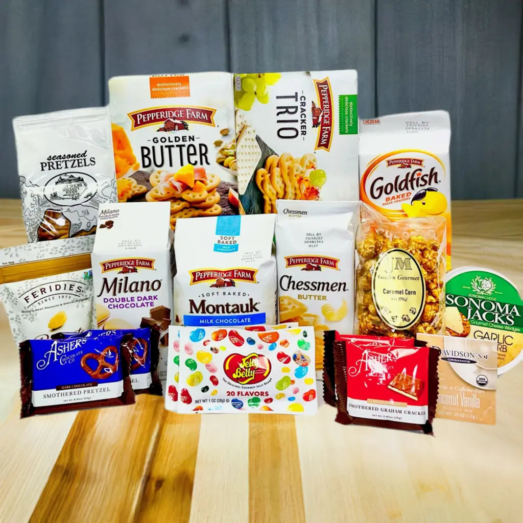 Gift basket with a blue bow containing snacks and treats on a neutral background