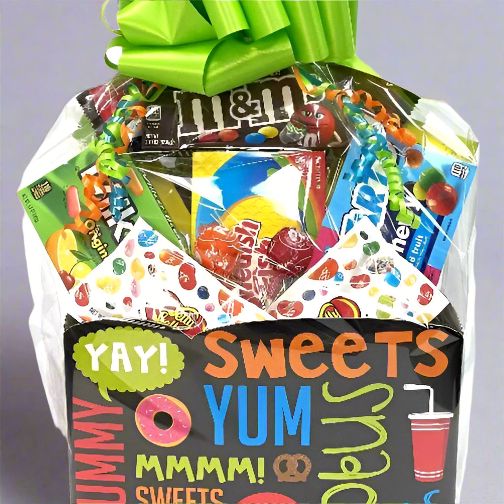 Gift basket filled with candy and snacks with a colorful bow on a white background
