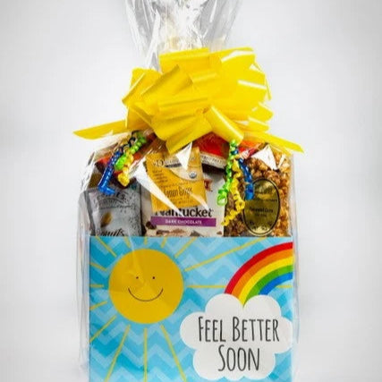 Gift basket filled with candy and snacks with a colorful bow on a white background