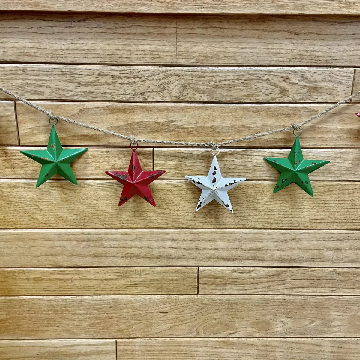 String of colorful star-shaped ornaments on a wooden wall