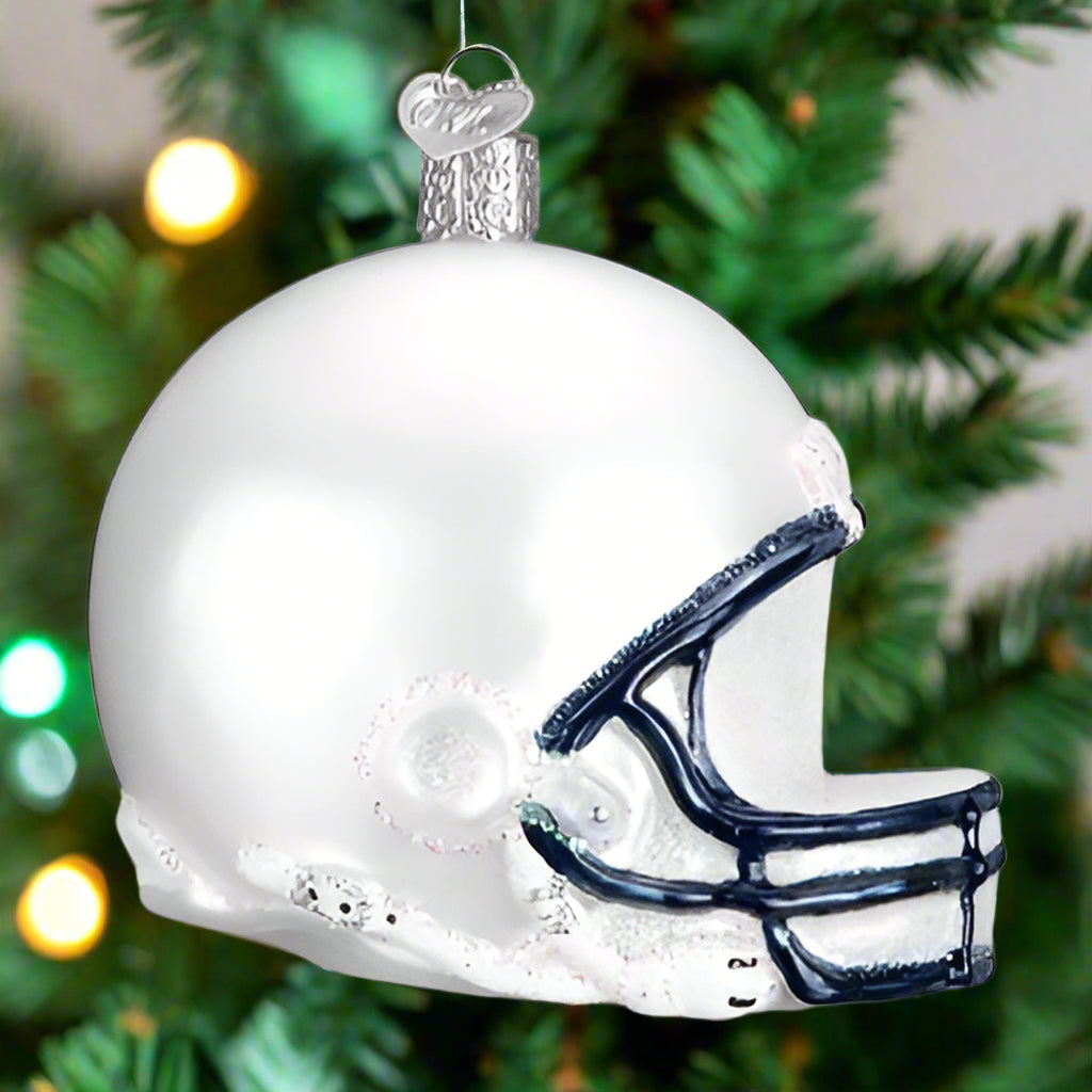 Glass football helmet ornament on a white background