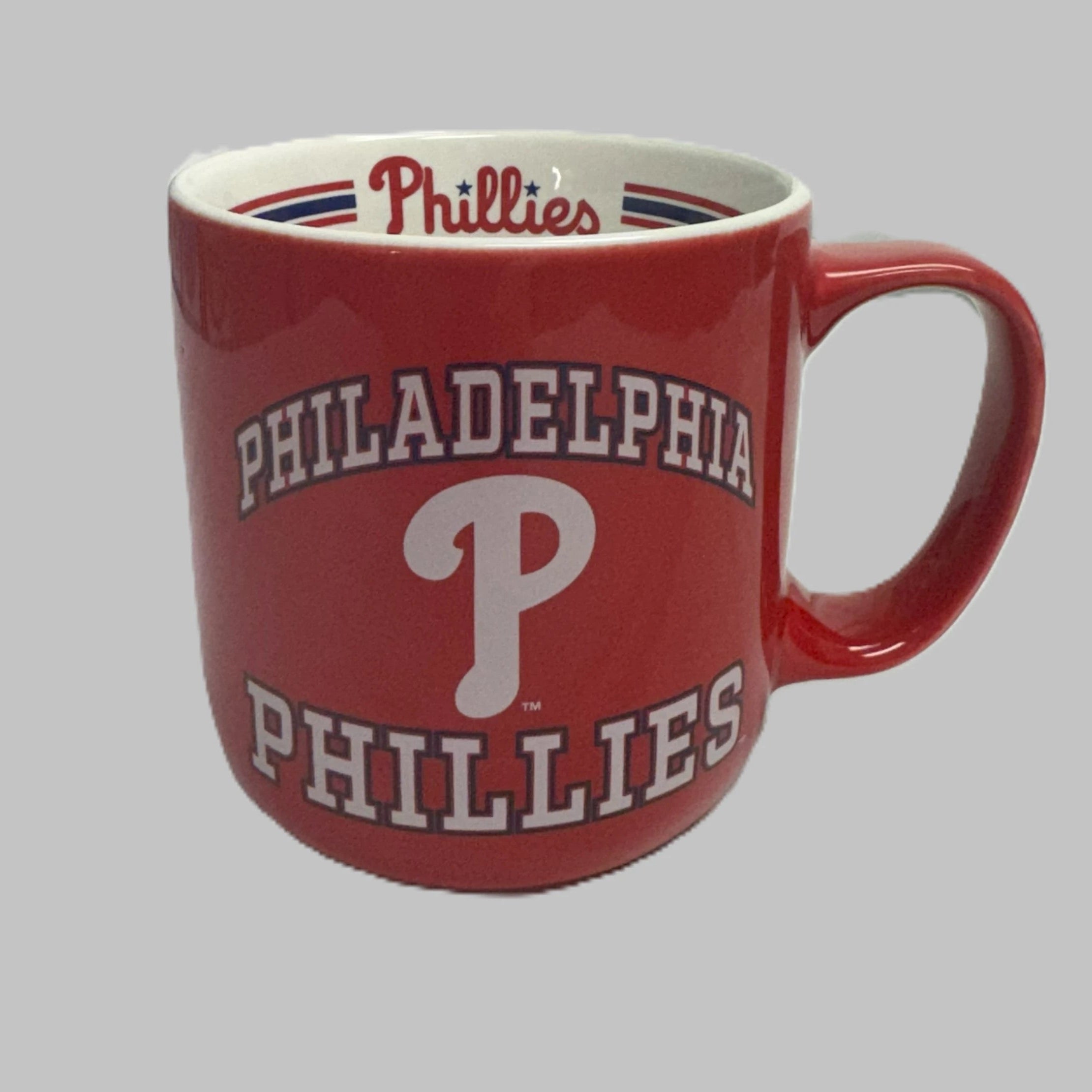 Red mug with 'Philadelphia Phillies' branding on a gray background