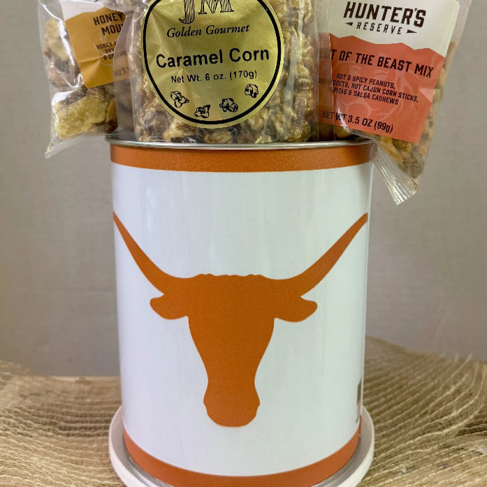 Snack basket with various treats including 'J.M. Caramel Corn' and 'Hunters Delight' in a container with a longhorn design.