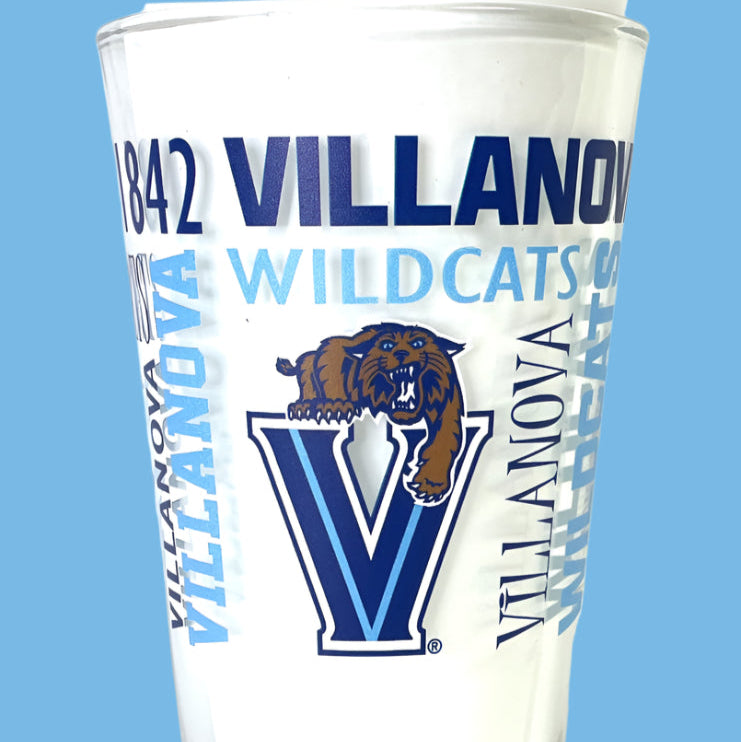 Glass tumbler with Villanova Wildcats branding on a blue background
