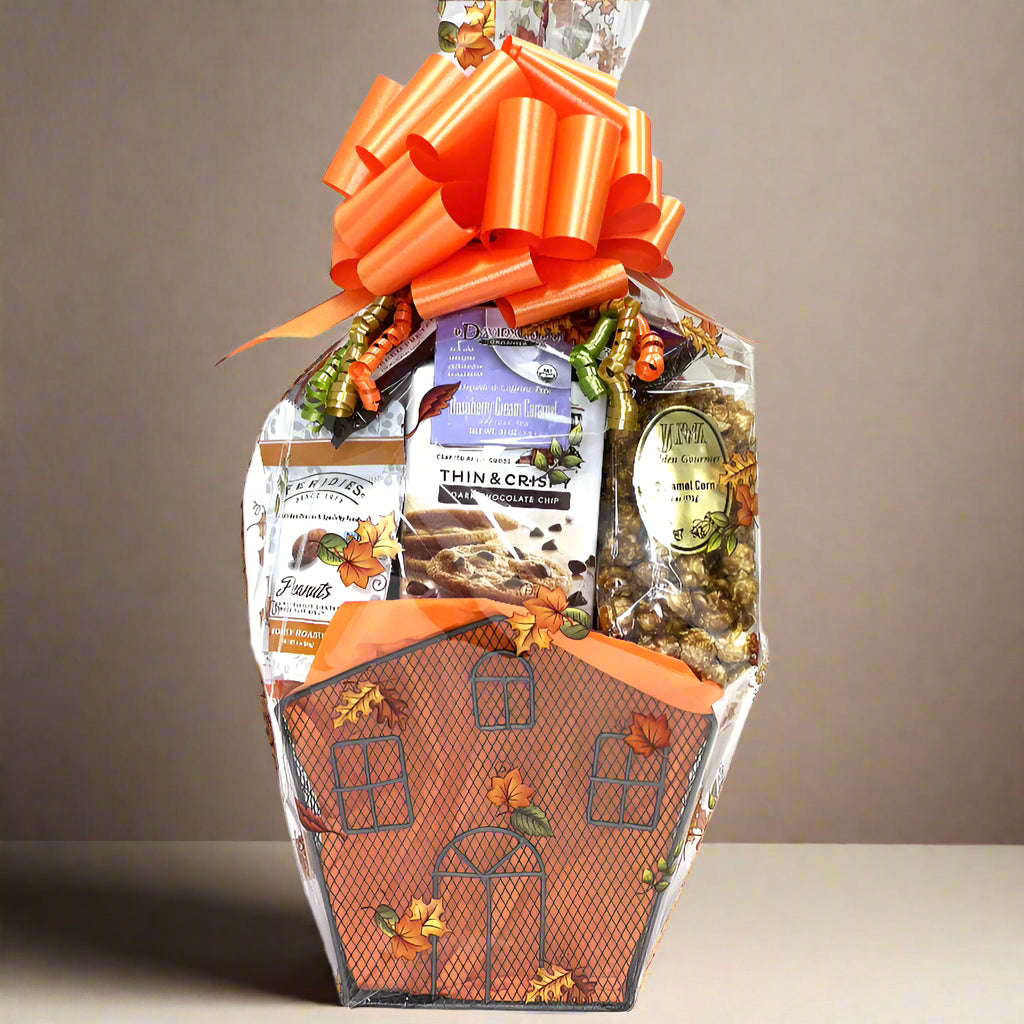 Gift basket shaped like a haunted house with Halloween-themed items on a white background