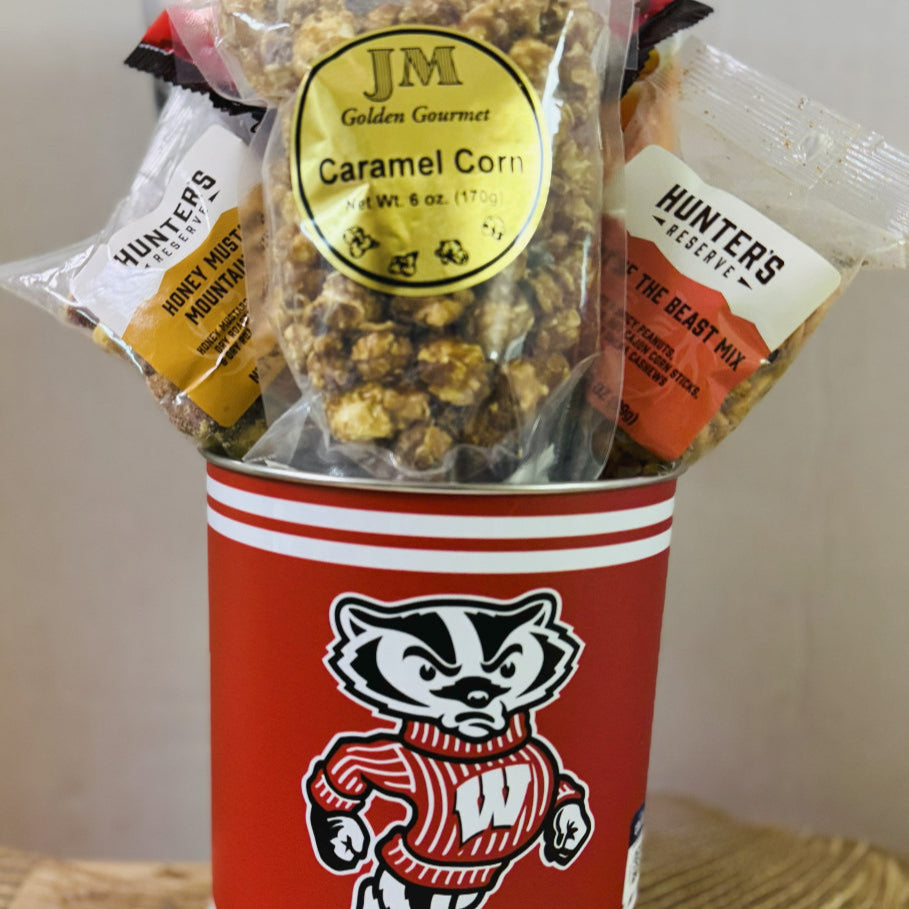 Snack mix in a red container with a badger logo on a wooden surface