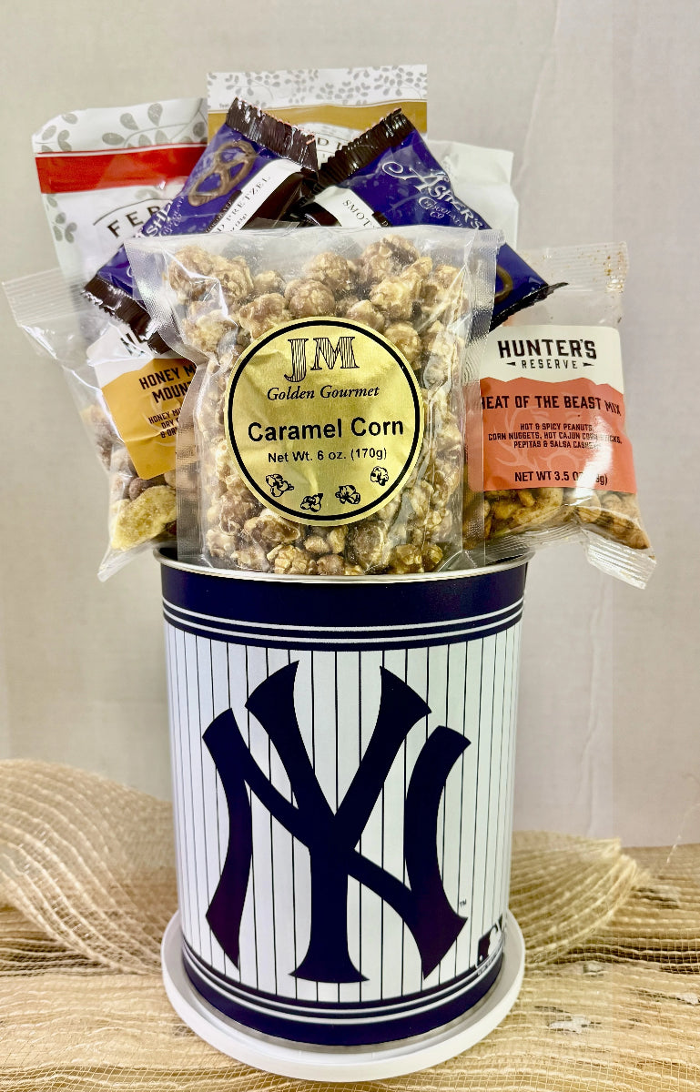 Gourmet popcorn gift set with a New York Yankees canister on a textured surface.