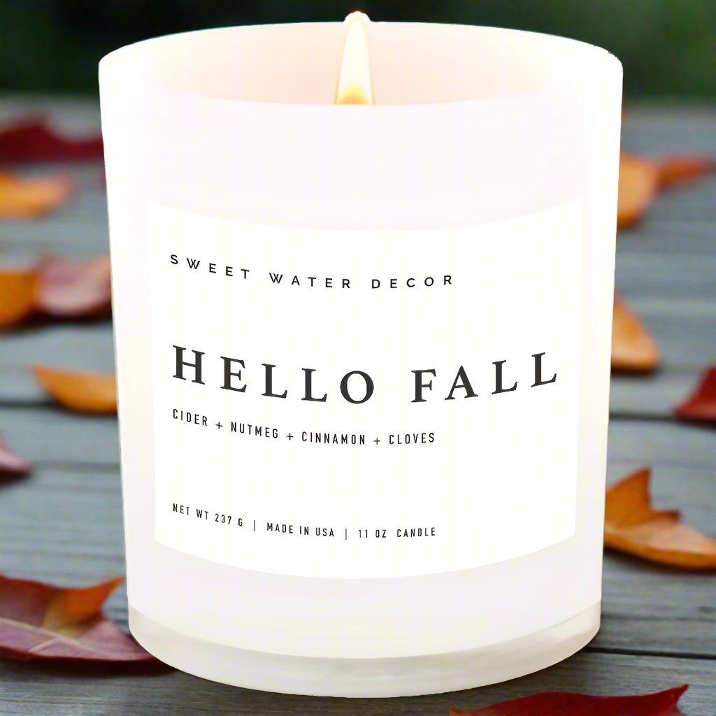 Candle with 'Hello Fall' label on a white background