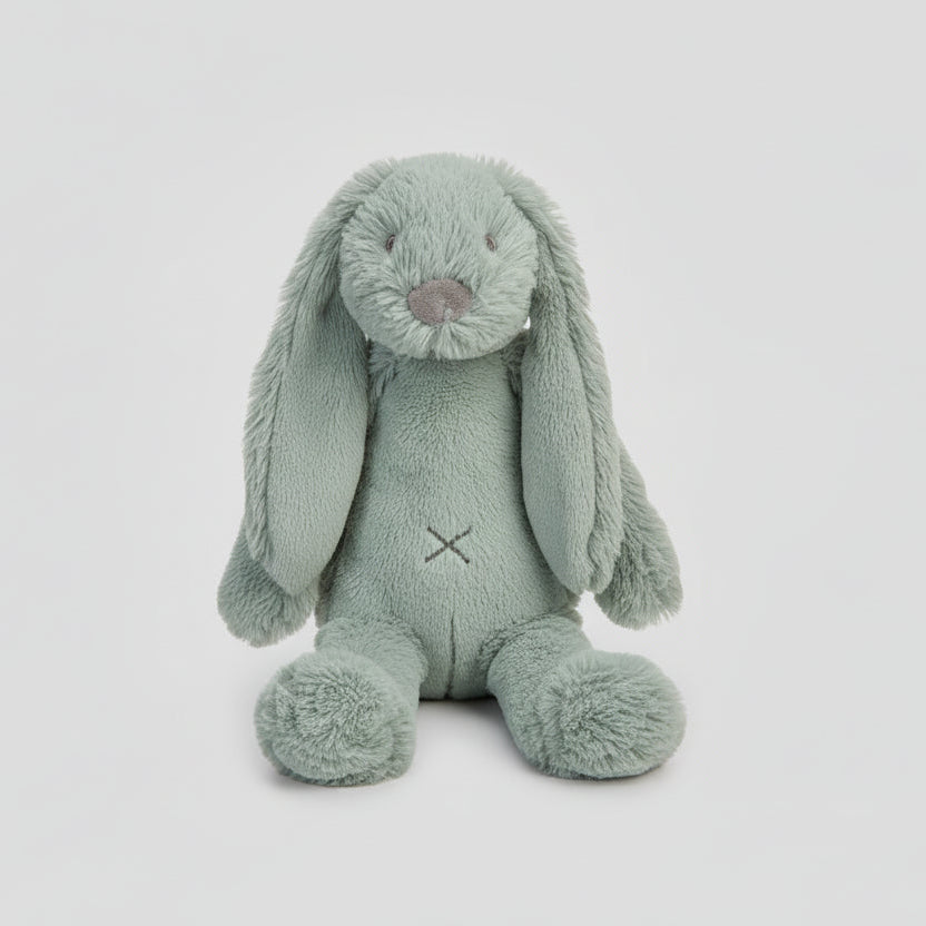 Easter basket with plush bunny, eggs, and candies on a white background