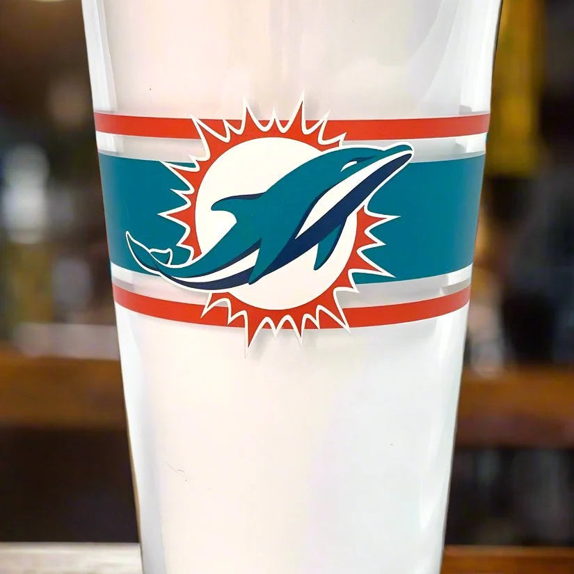 Glass with a sports team logo on a wooden surface