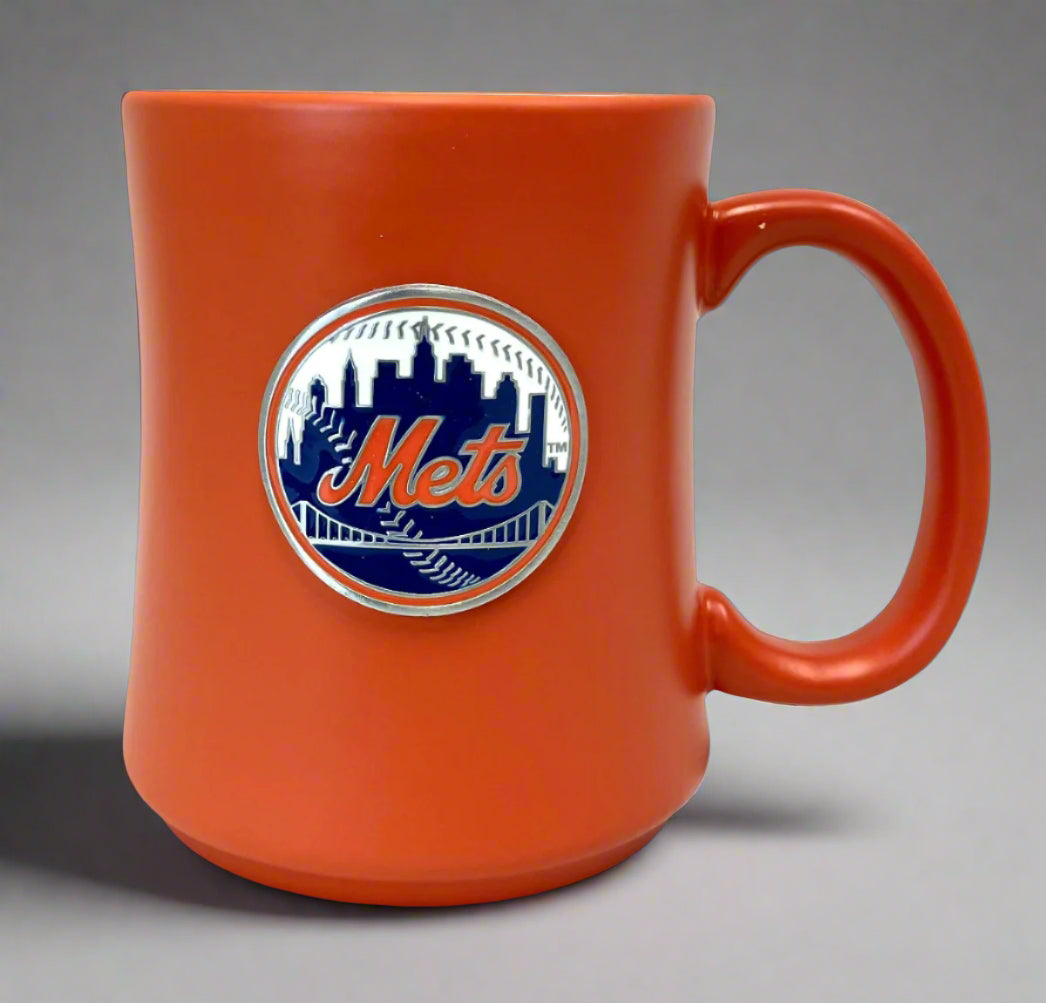Orange mug with Mets logo on a gray background