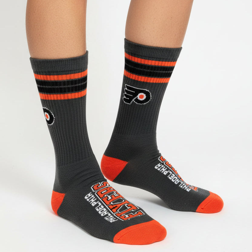 Pair of black and red Philadelphia Flyers socks on a white background