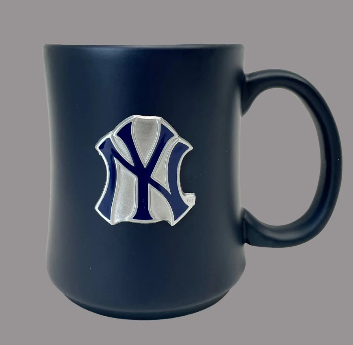 Navy blue mug with a logo on a gray background