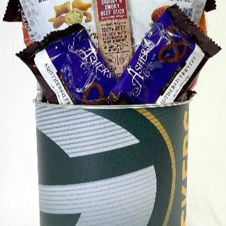 Snack basket with various items including candy and chips in a Green Bay-themed container.