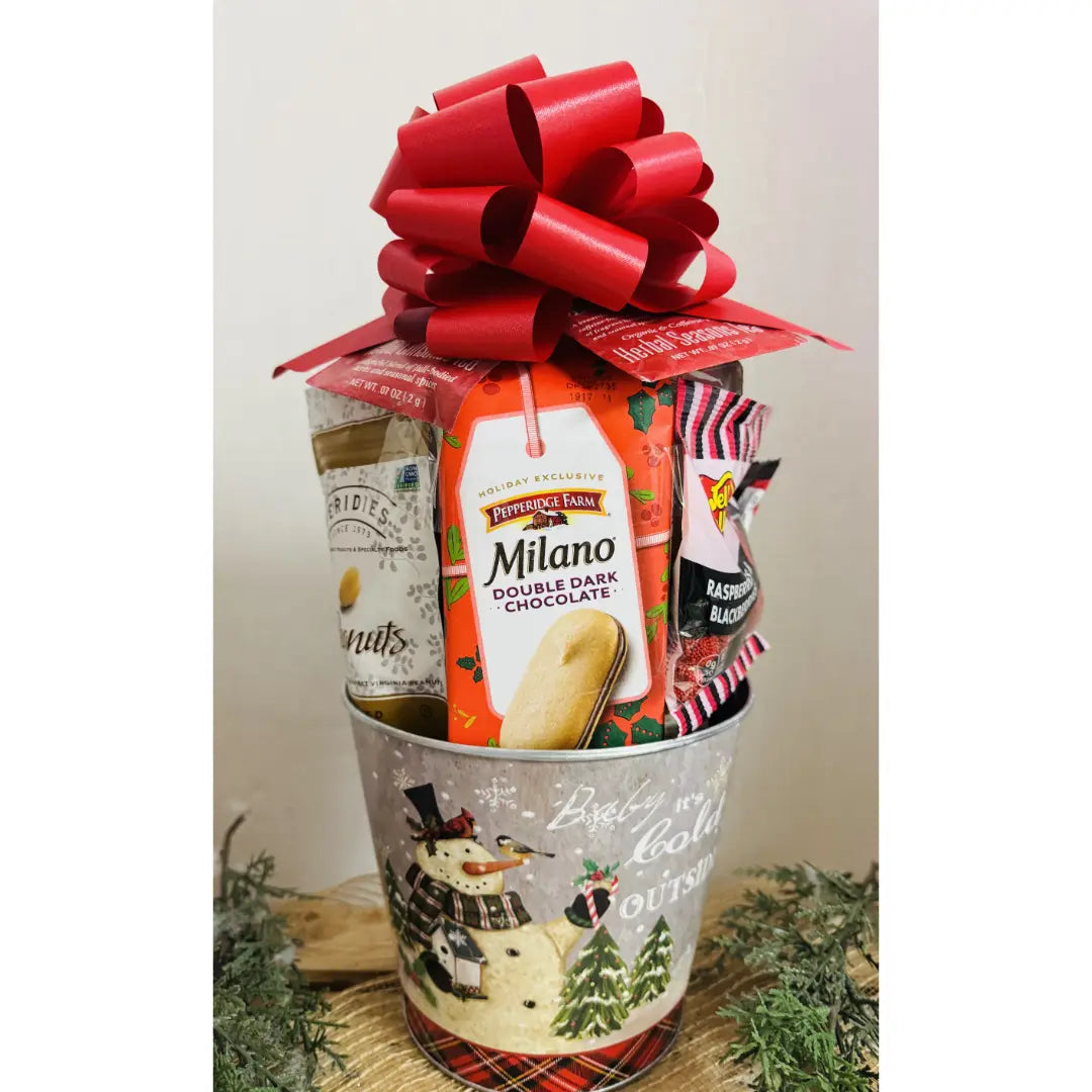 Gift basket with Milano cookies and other items on a decorative surface with a red bow.