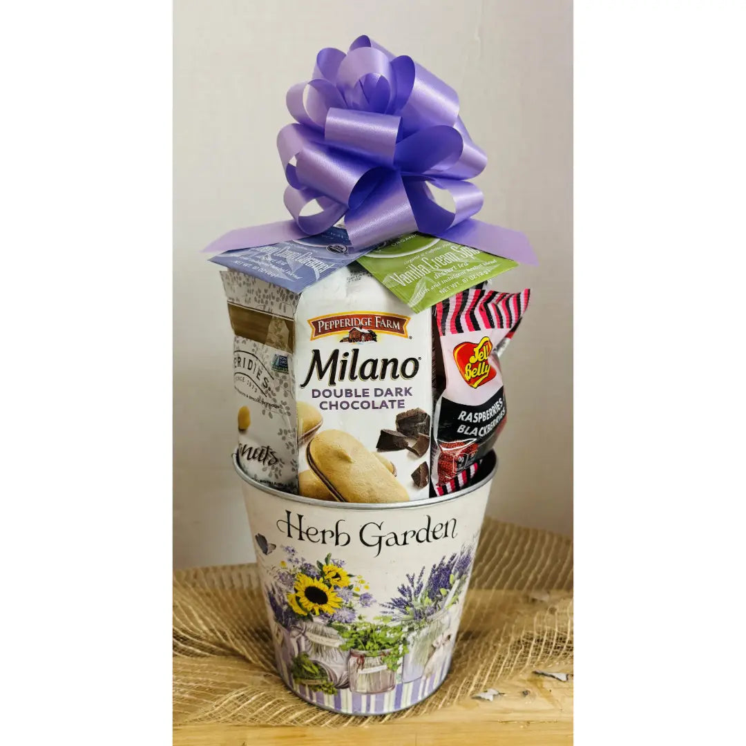 Gift basket with Milano chocolate, candy, and a purple bow on a white background