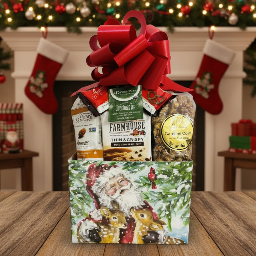 Gift basket with a red bow containing snacks and tea, featuring a Santa Claus design on the box.