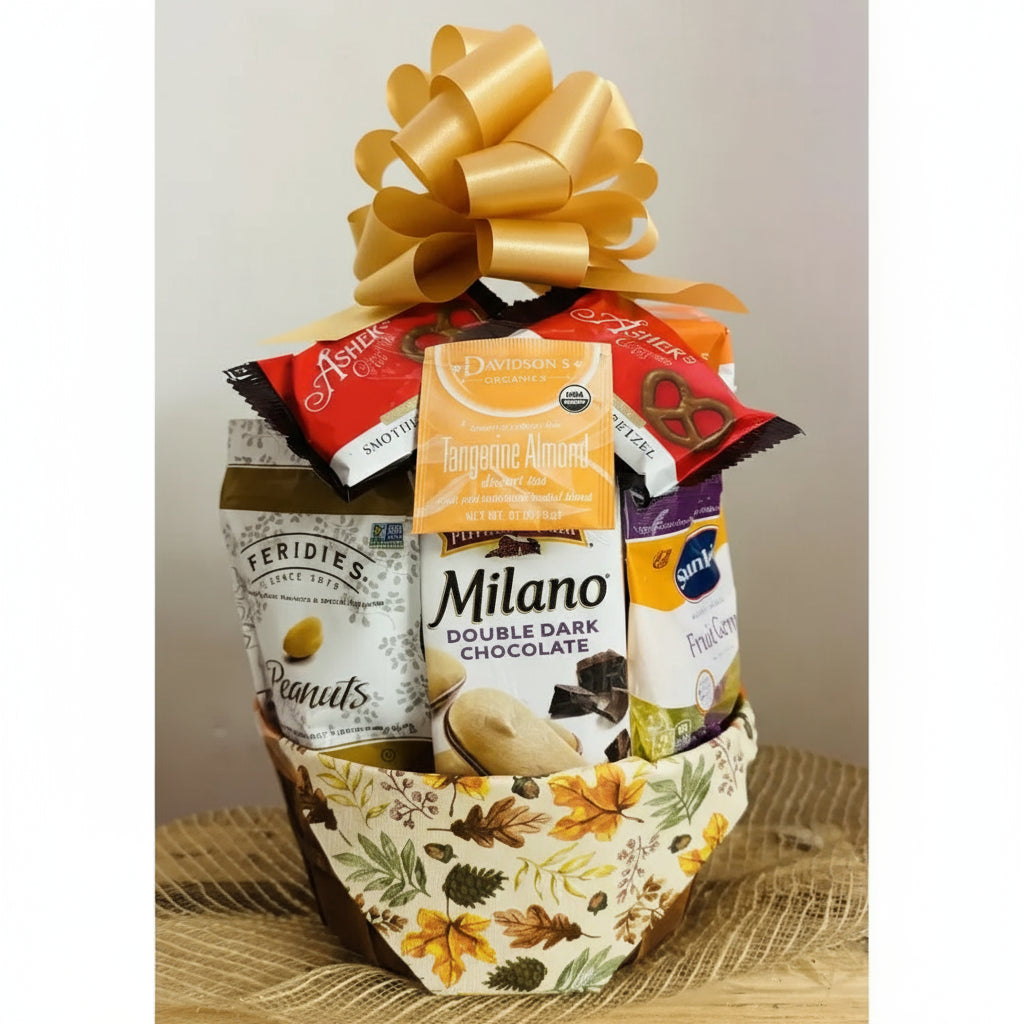 Gift basket with assorted snacks and a gold bow on a neutral background