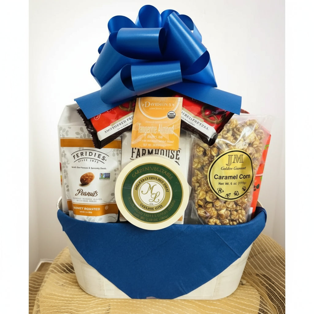 Gift basket with a blue bow containing snacks and treats on a neutral background