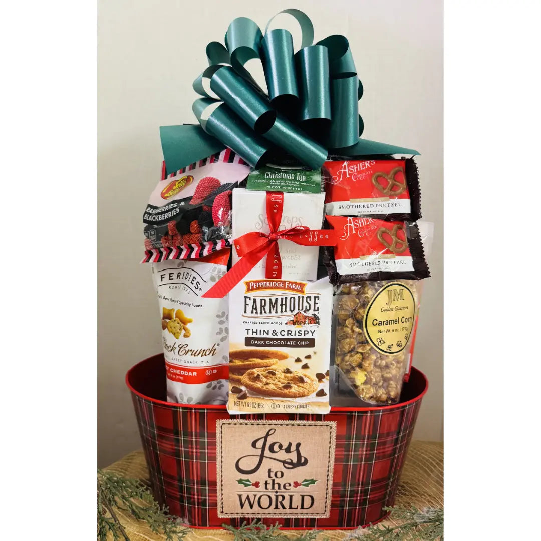 Gift basket with snacks and a large bow, featuring a 'Joy to the World' tag.