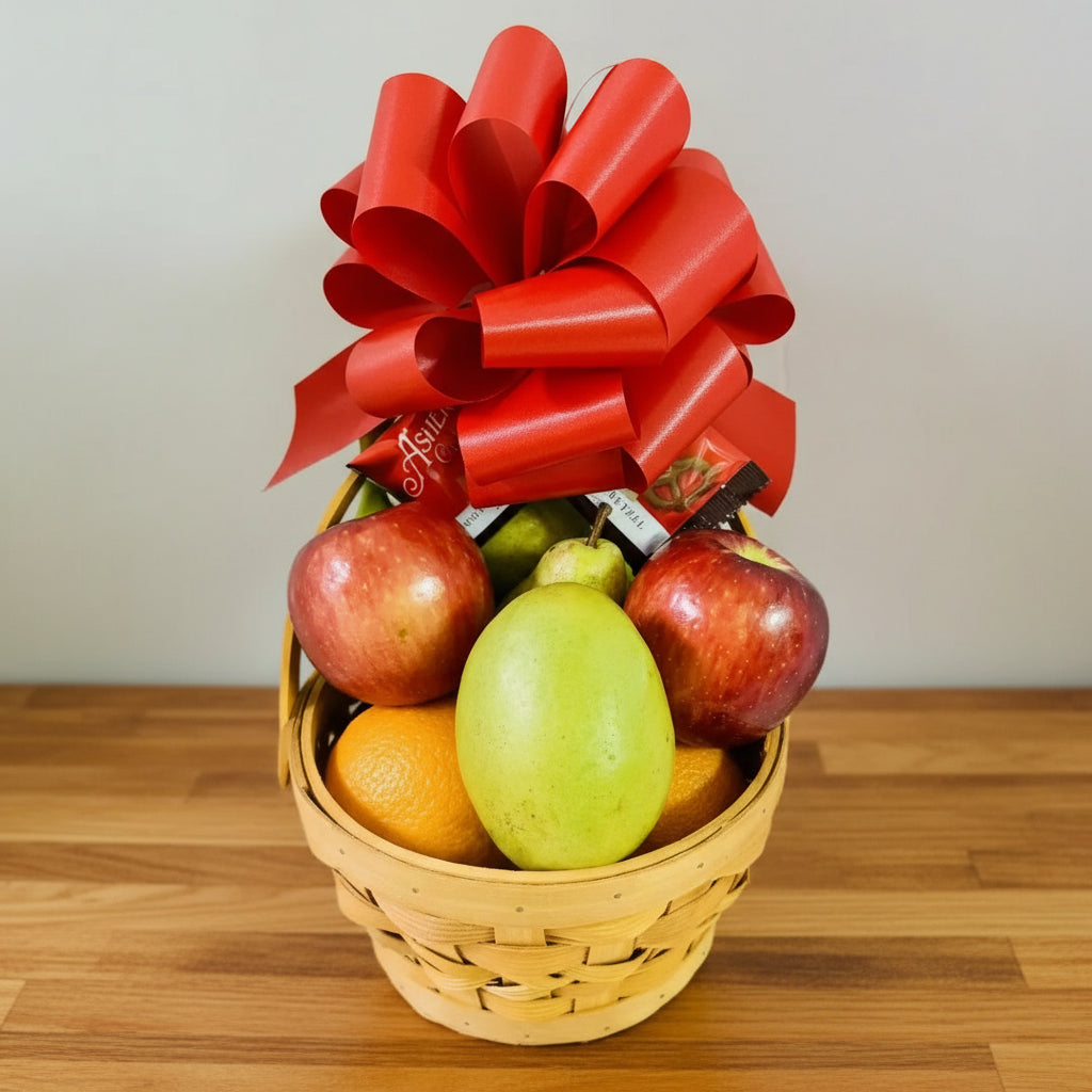 Fruit basket with red bow on a light background